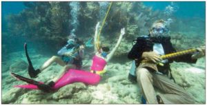 Participants pretend to play mock musical instruments during the Lower Keys Underwater Music Florida Keys Reefs